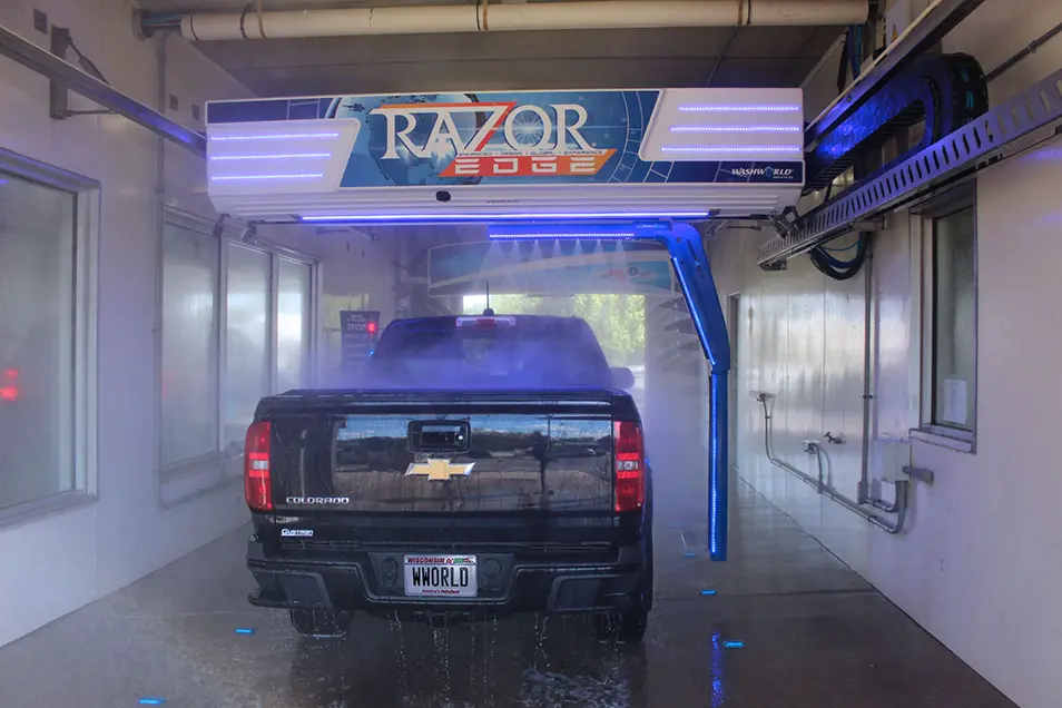 back of black Chevy truck in car wash